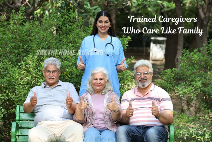 Trained caregiver from Sakthi Home Nursing in Coimbatore providing friendly and professional support to happy senior citizens in a garden setting